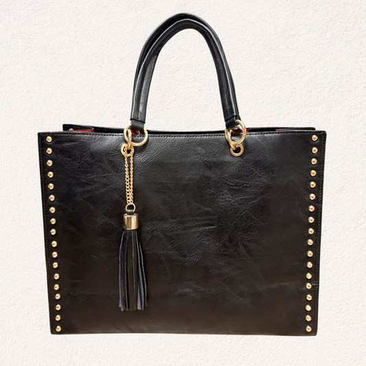 black shopper bag with gold details and tassel