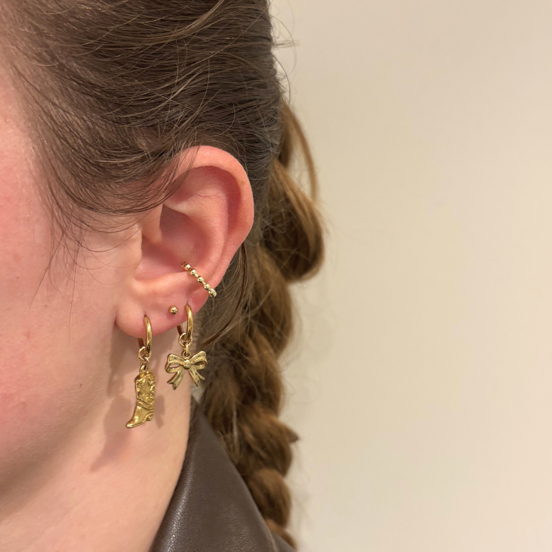 Kleine strikjes oorbellen aanfoto stainless steel goud en zilverkleurig