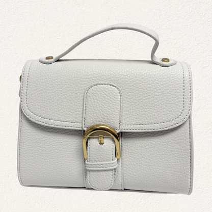 white handbag with gold clasp and shoulder strap